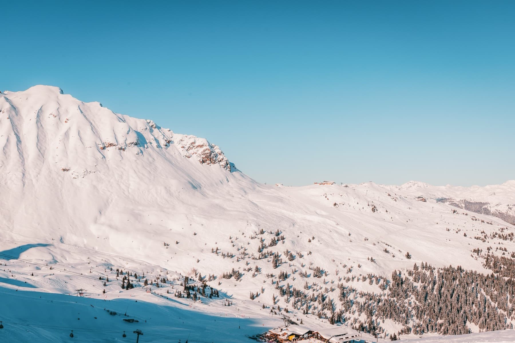 A gentle, freshly groomed slope in Courchevel at first light