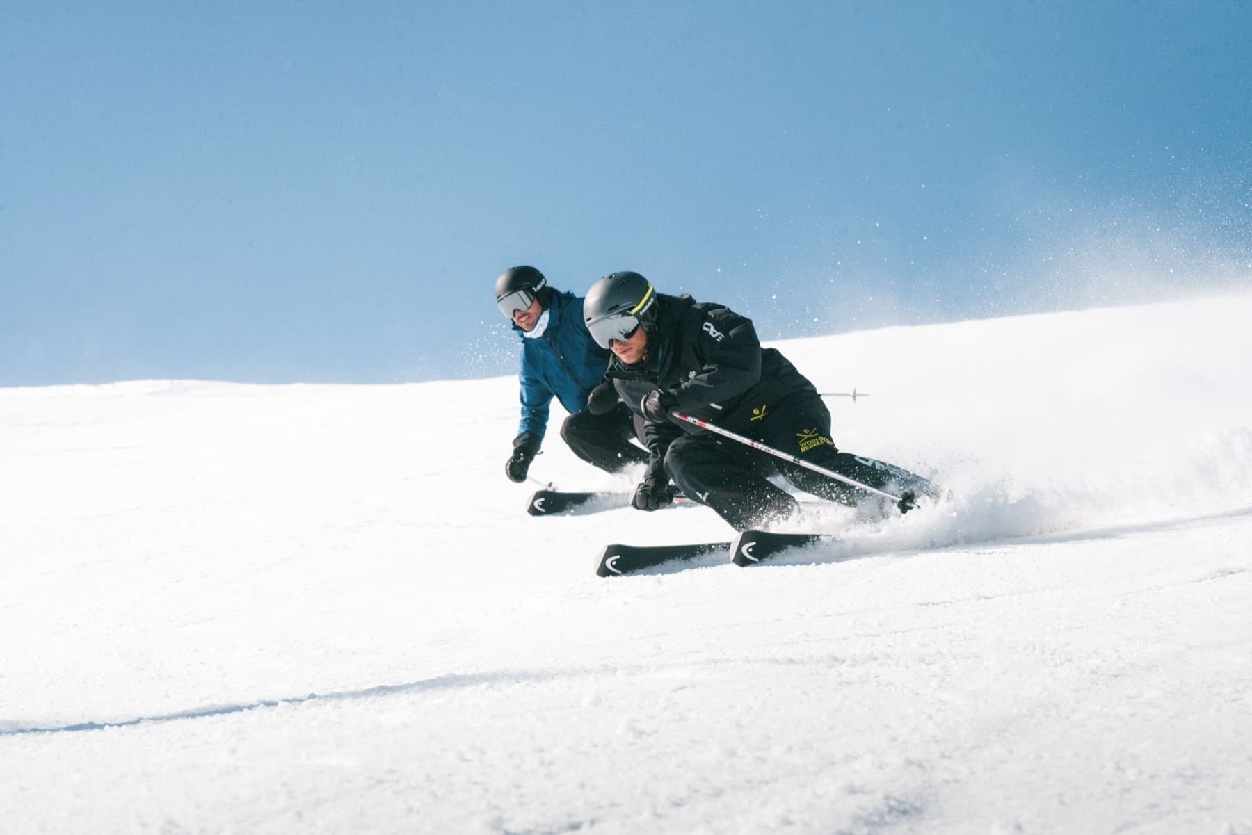 A skier carving a turn on a groomed Courchevel piste
